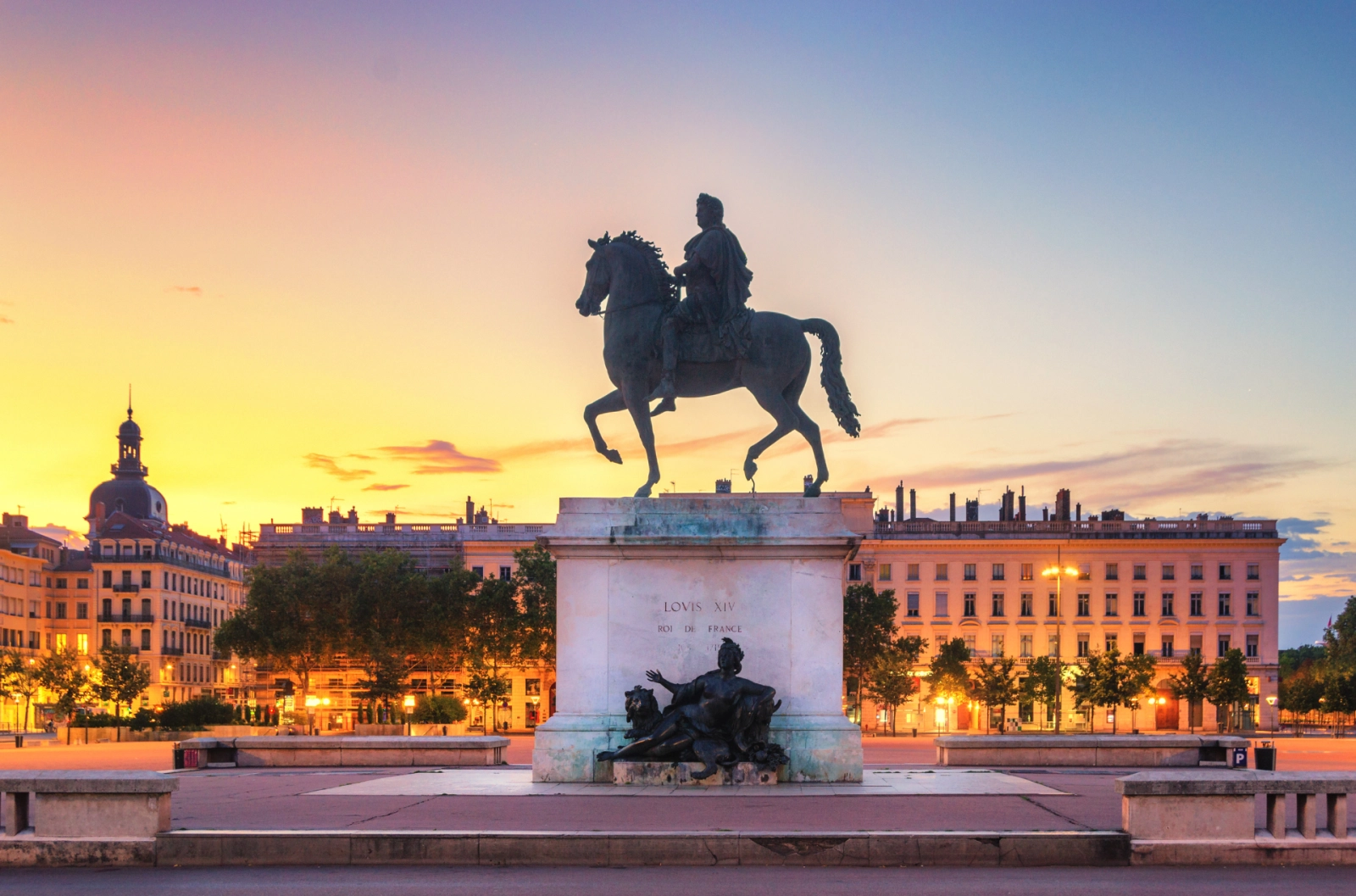 Place Bellecour in Lyon at sunset with a statue of Louis XIV – France’s gastronomic and cultural capital, perfect for travelers seeking immersive urban experiences beyond Paris.