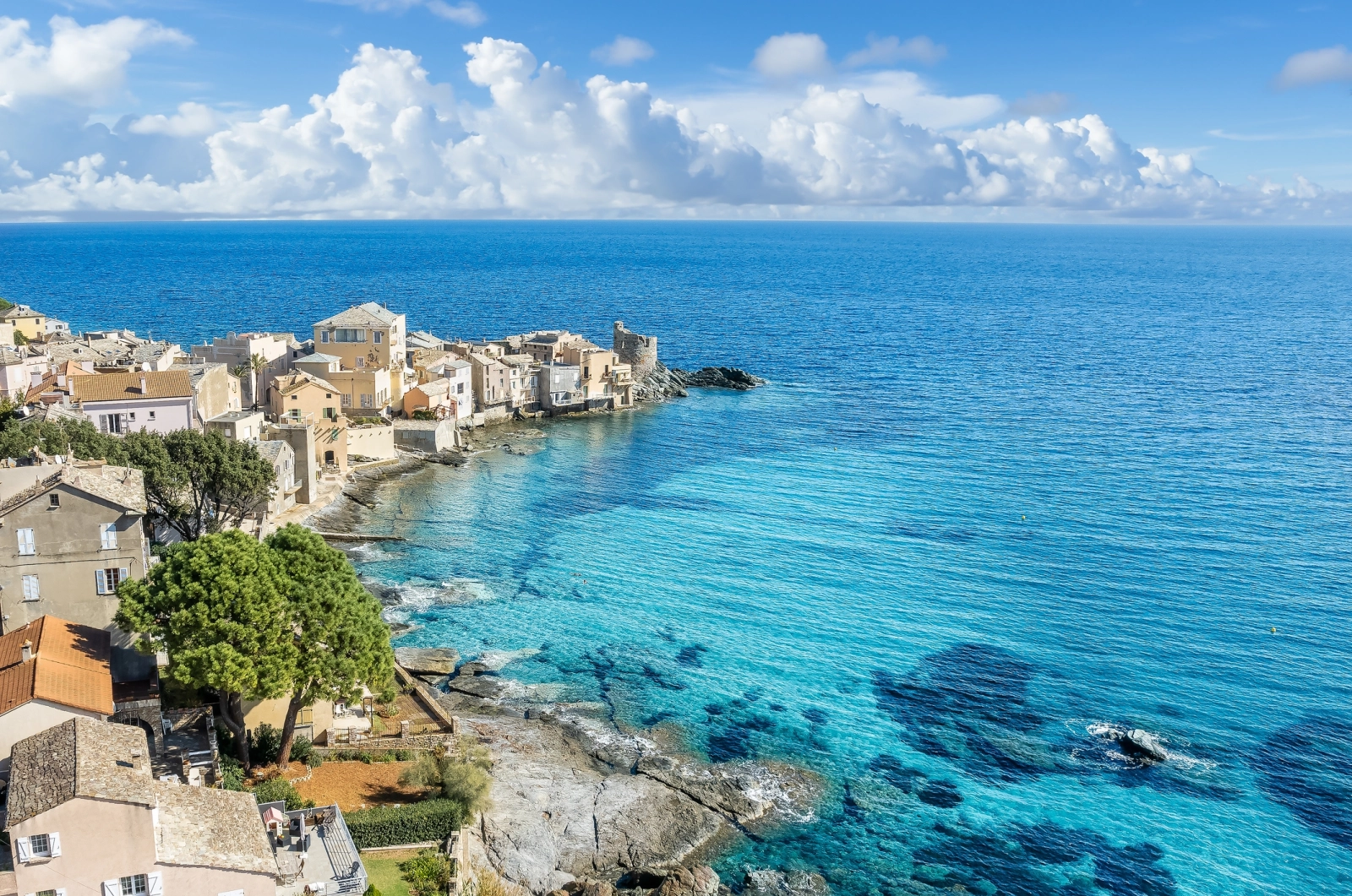 The pastel-hued village of Erbalunga perched on the Cap Corse coastline in Corsica – a stunning blend of Mediterranean beauty and French island authenticity.